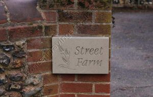 Customers photo: York stone house name sign. With Dolphin font and Barley motif, hung on hidden pin fixings.