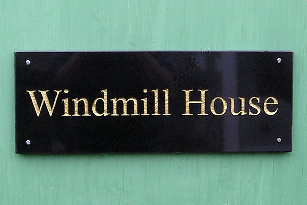 Windmill house, house sign in Black Absoluto granite Times Roman standard title-case font engraved and finished gold.