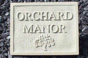 Indian sandstone house name sign. Carved in-relief "Orchard Manor" and Appletree motif. Font is Times Roman standard.